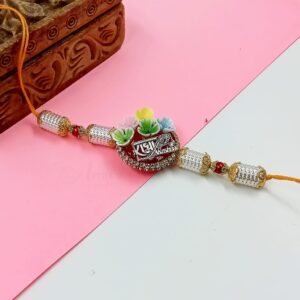 ARNAS 1 PC RED ROUND ART METAL SHREE RADHA MOTIF DESIGNER RAKHI