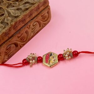 ARNAS 1 PC GOLDEN ROUND MOTIF ART METAL RED DESIGNER RAKHI