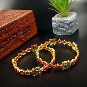 ARNAS 2 PAIR GOLDEN METAL 2X6 DESIGNER RED & GREEN STONE MOTIVE BANGLES